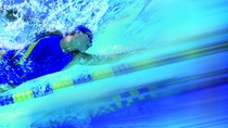 Women swimming in pool, underwater view (blurred motion) Women swimming in pool, underwater view (blurred motion)